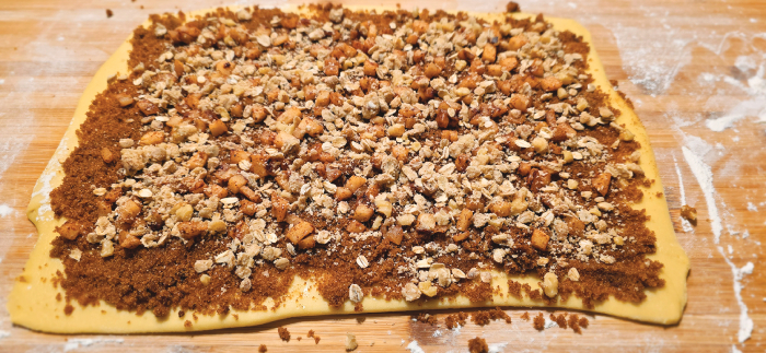 Sprinkle the top of the dough with apple, streusel, and cinnamon spread fillings.